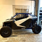 side view of polaris pro xp in shop with wci offroad pro xp cage