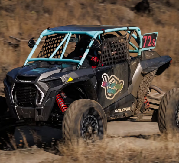Polaris RZR Turbo S with WCI Off-Road race cage in the desert in motion