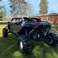 Black can-am maverick r max in the grass with wci offroad cage and rear bumper