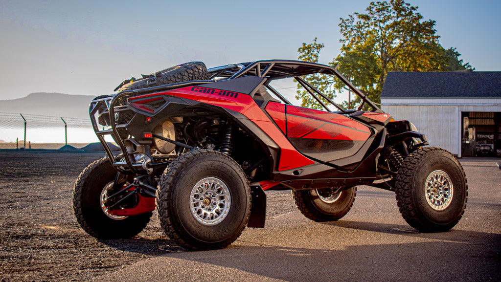 can am maverick r in parking lot with wci offroad mav r roll cage, rear bumper, and spare tire carrier