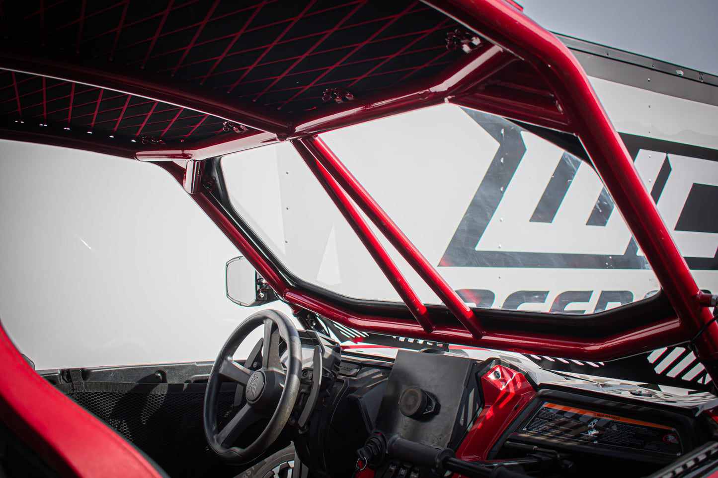interior with wci offroad honda talon cage, red with intrusion bars and a windshield