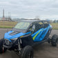 Polaris rzr turbo r outside with a wci offroad roll cage and windshield