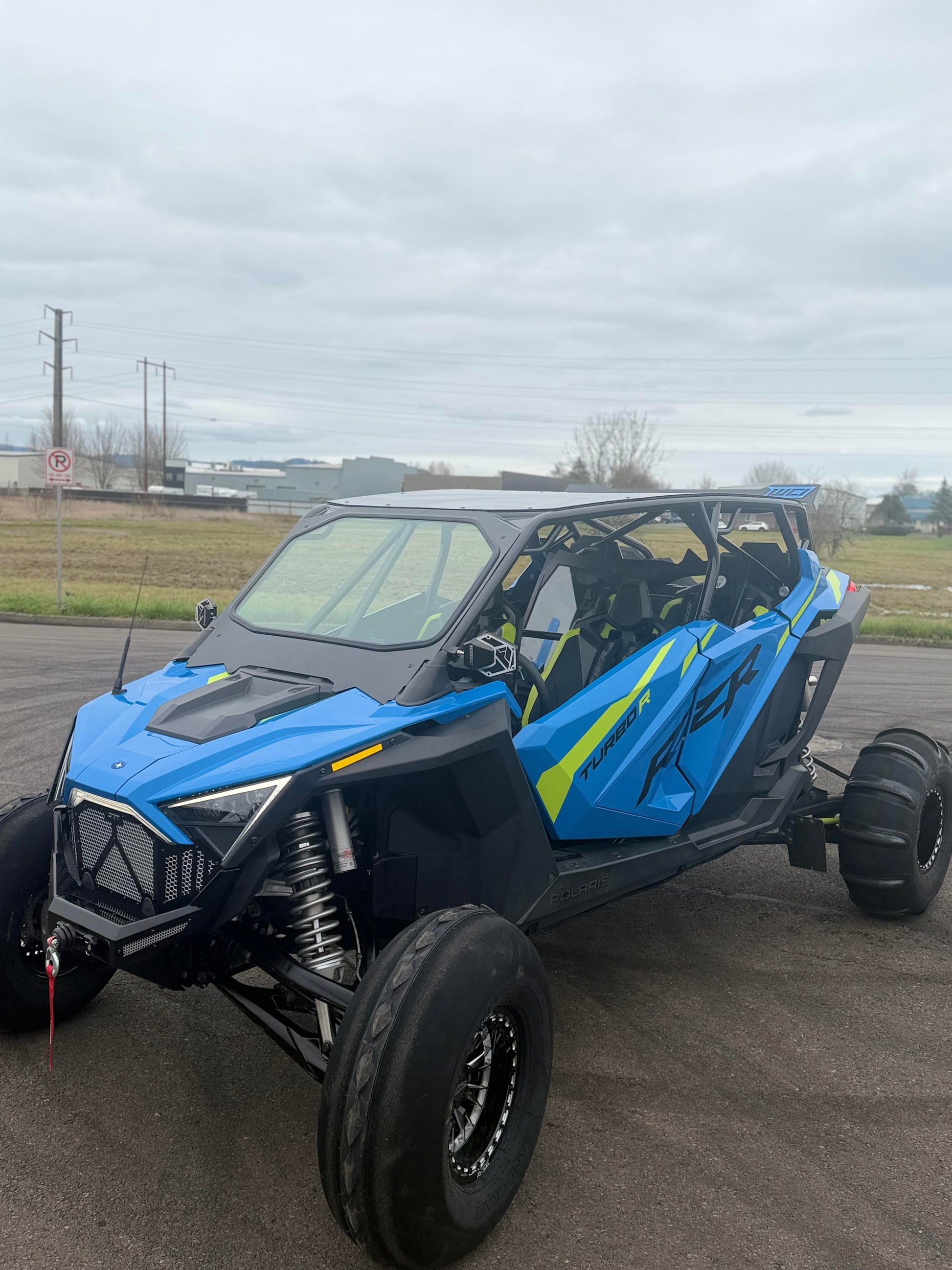 Polaris rzr turbo r outside with a wci offroad roll cage and windshield