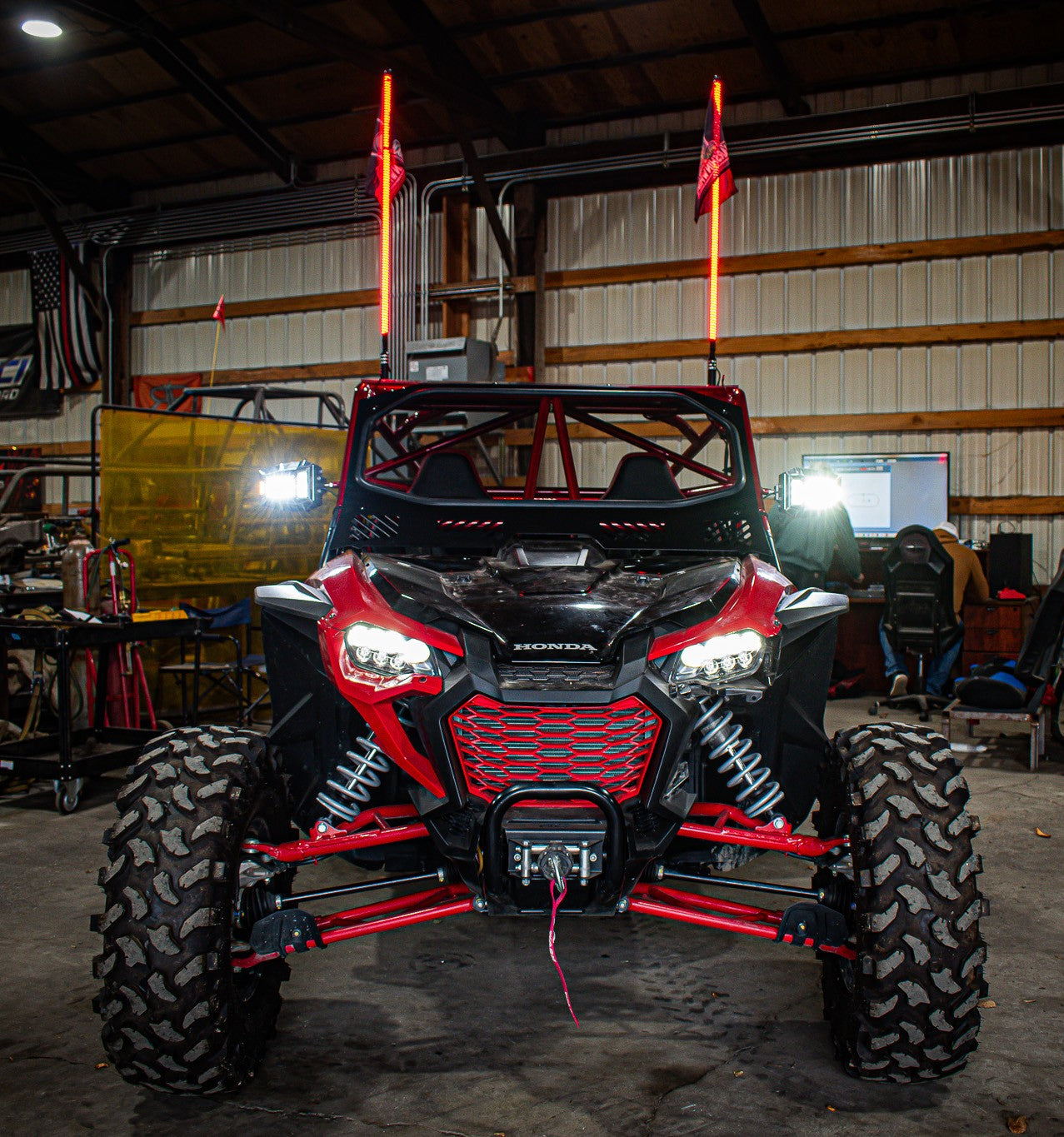 red and black honda talon with wci offroad honda talon roll cage with full vented windshield and light whips 